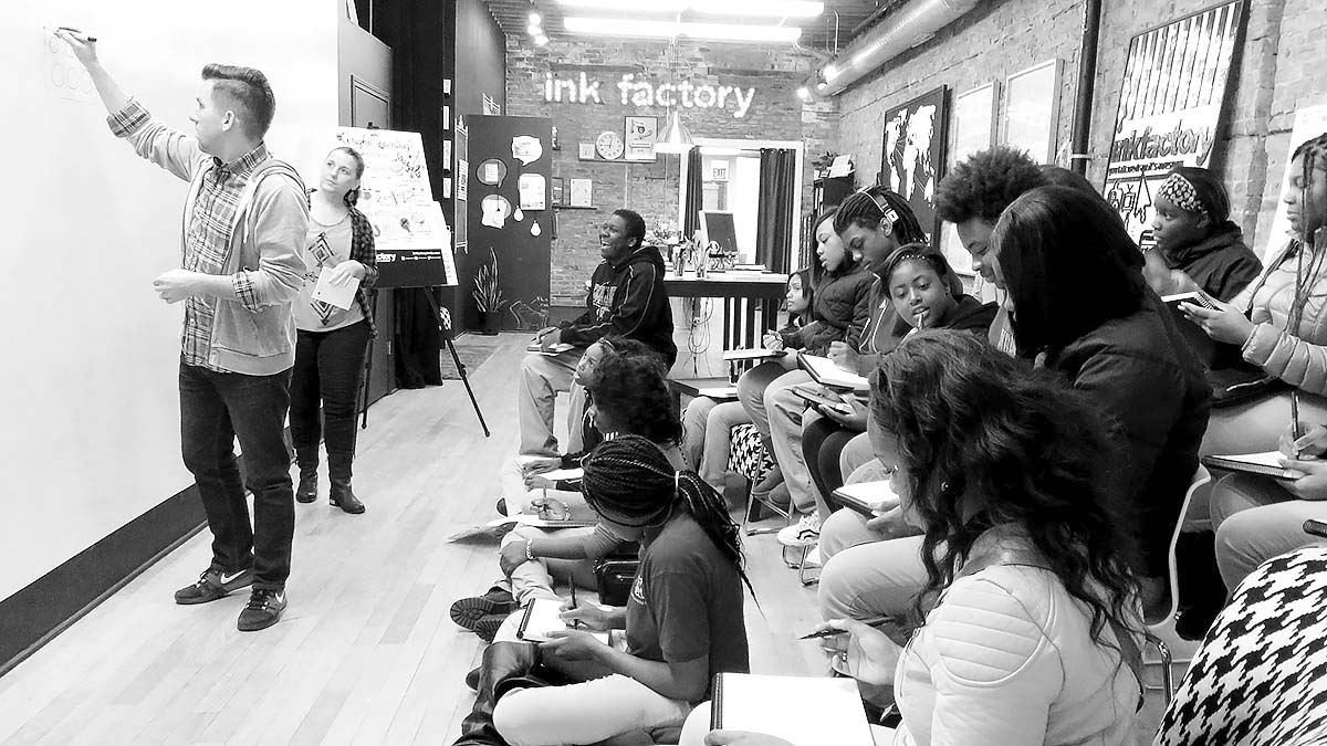 Students from EMBARC watch Ryan demonstrate visual note-taking