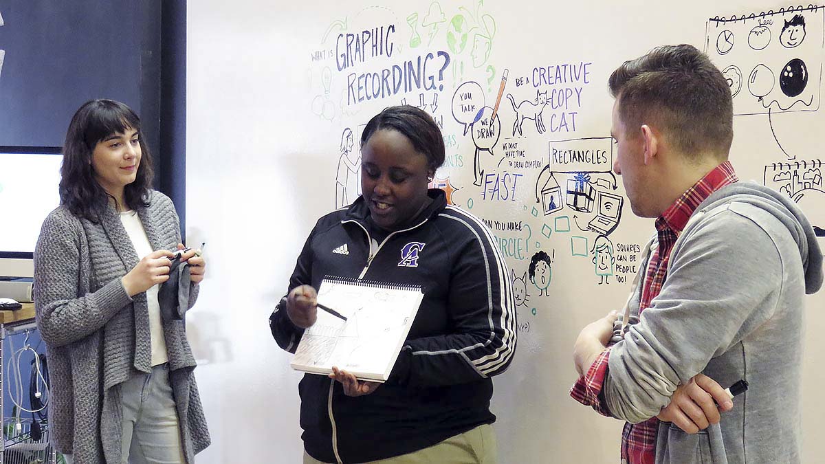 An EMBARC student explains her visual notes to the group