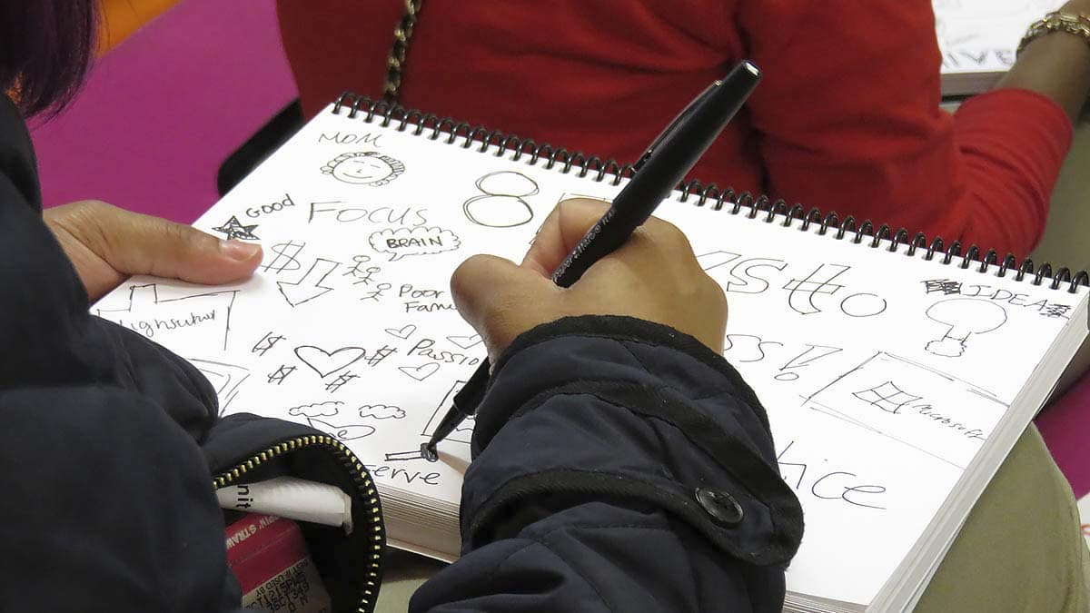A student visualizes ideas in his sketchbook