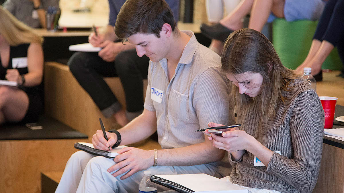 Participants check their phones for examples of visual communication - emojis!