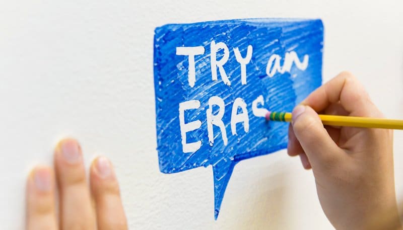 Use a pencil eraser to create negative space while writing down office whiteboard ideas