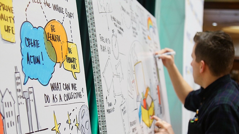 An artist creates a graphic recording live