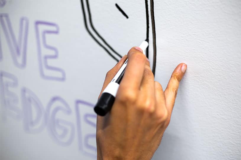 Use your pinky to stabilize your hand when writing down your office whiteboard ideas