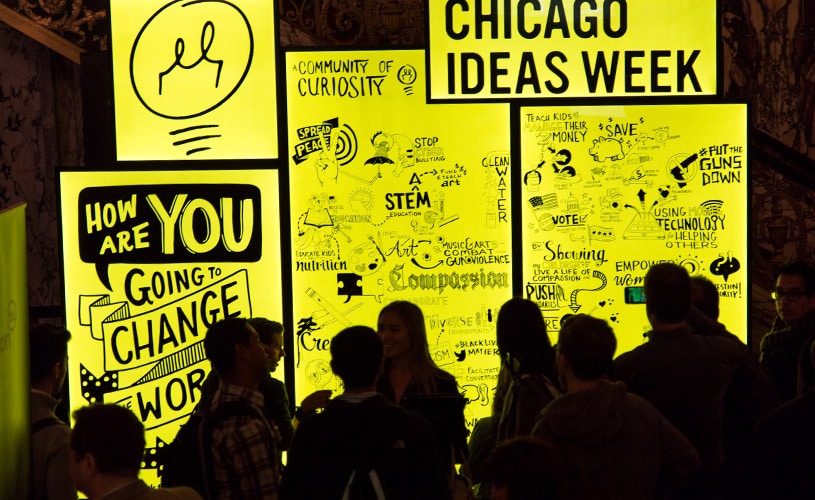 Visual notes taken on a large LED panel sit on display at Chicago Ideas Week