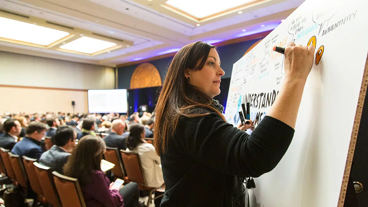Visual recording being drawn live in a large meeting