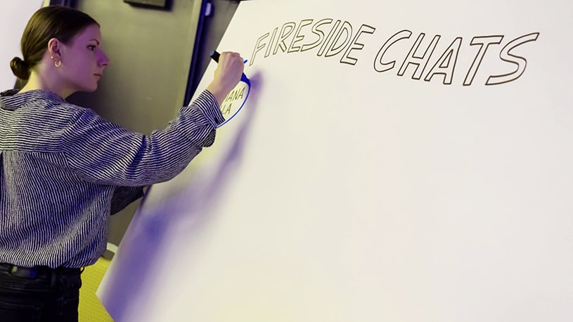 An artist prepares to draw visual notes on a white board