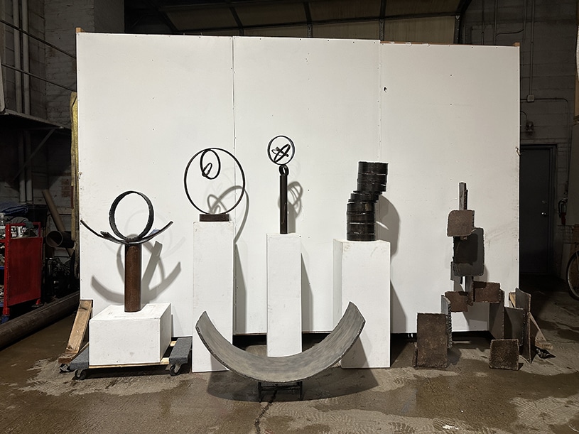 Multiple sculptures in front of a white backround